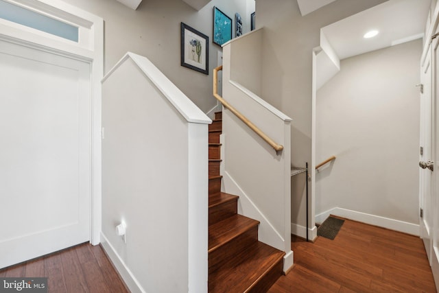 staircase featuring hardwood / wood-style flooring