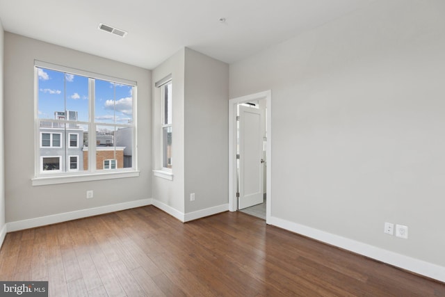 unfurnished room featuring dark hardwood / wood-style floors