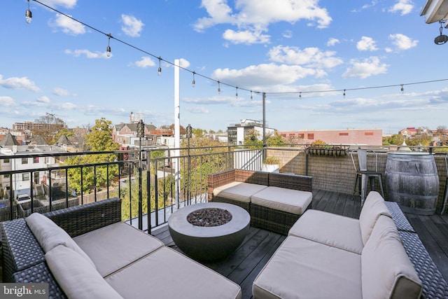 balcony with an outdoor living space with a fire pit