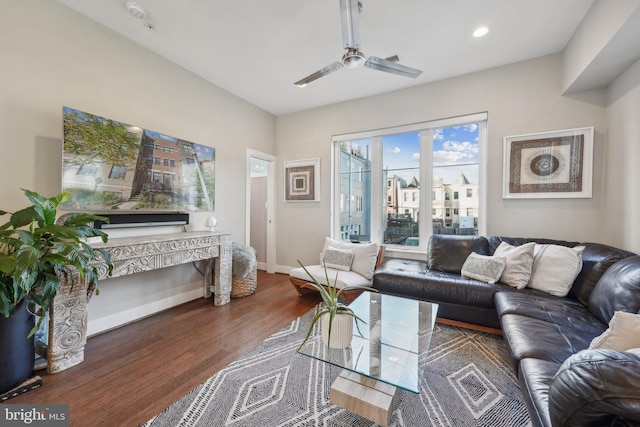 living room featuring ceiling fan and dark hardwood / wood-style flooring