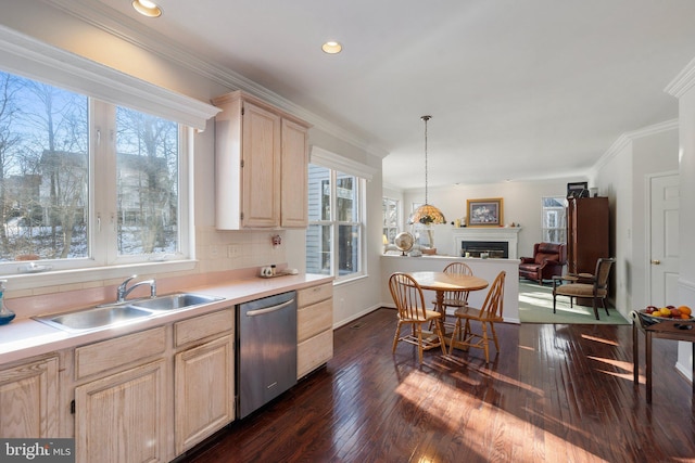 kitchen with light brown cabinetry, sink, ornamental molding, and dishwasher