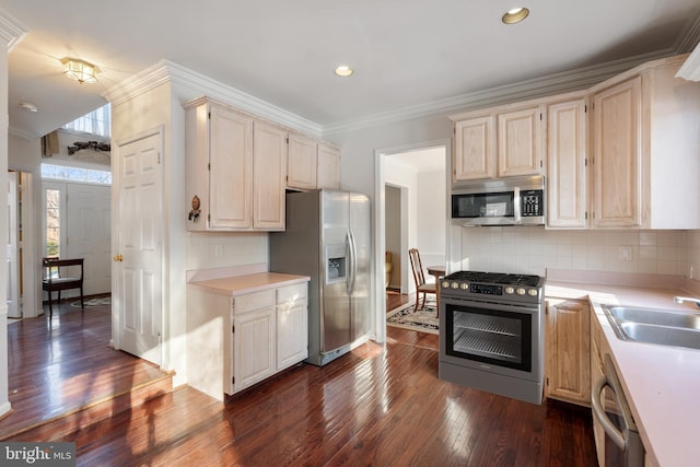 kitchen featuring sink, dark hardwood / wood-style flooring, decorative backsplash, stainless steel appliances, and crown molding