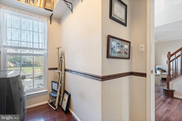 corridor featuring washer / clothes dryer, dark hardwood / wood-style floors, and a healthy amount of sunlight