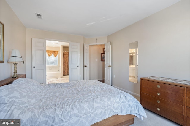 carpeted bedroom with connected bathroom