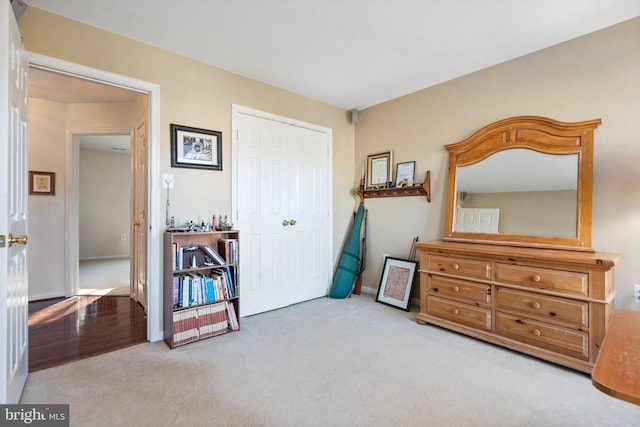 bedroom featuring light colored carpet and a closet