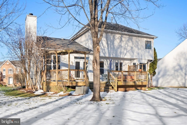 snow covered property featuring a wooden deck