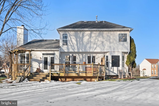 snow covered property featuring a wooden deck