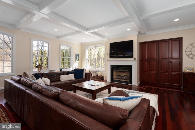 living area with dark wood finished floors, a fireplace, coffered ceiling, and beamed ceiling