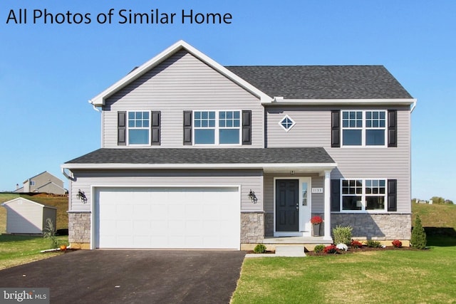 view of front facade with a front lawn and a garage