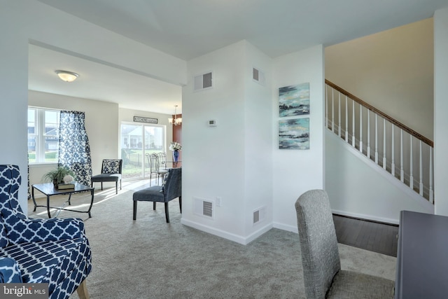 interior space with carpet floors and a notable chandelier