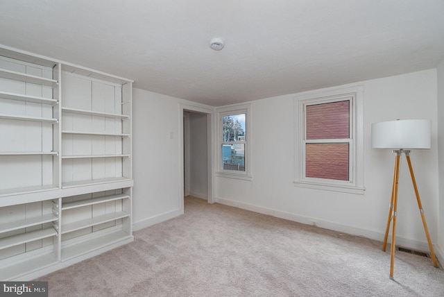 unfurnished bedroom with light colored carpet