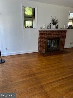 unfurnished living room with wood-type flooring and a fireplace