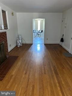 unfurnished living room with hardwood / wood-style flooring and a fireplace