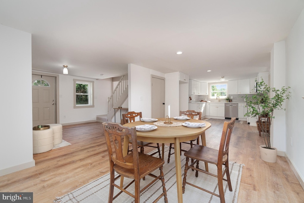 dining room featuring sink and light wood-type flooring