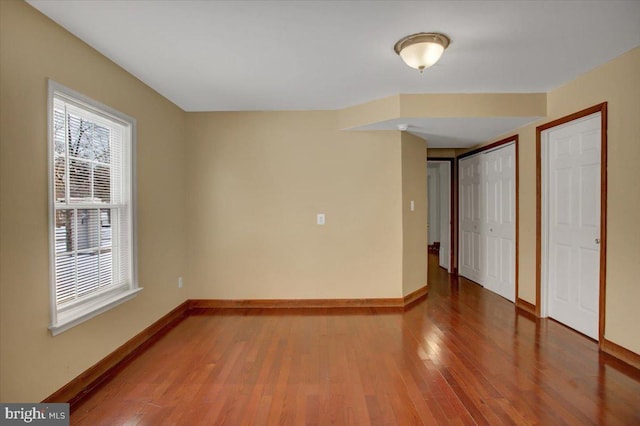 unfurnished room with hardwood / wood-style flooring