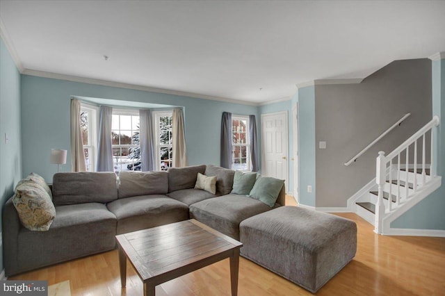 living room featuring crown molding and light hardwood / wood-style floors