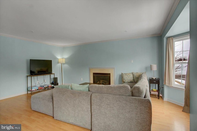 living room featuring light hardwood / wood-style flooring and ornamental molding