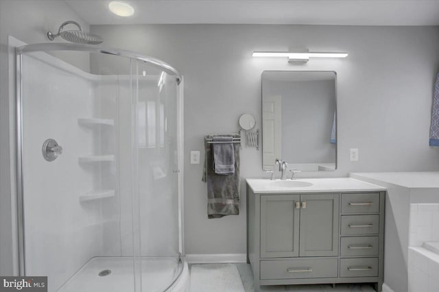 bathroom with a shower with shower door and vanity