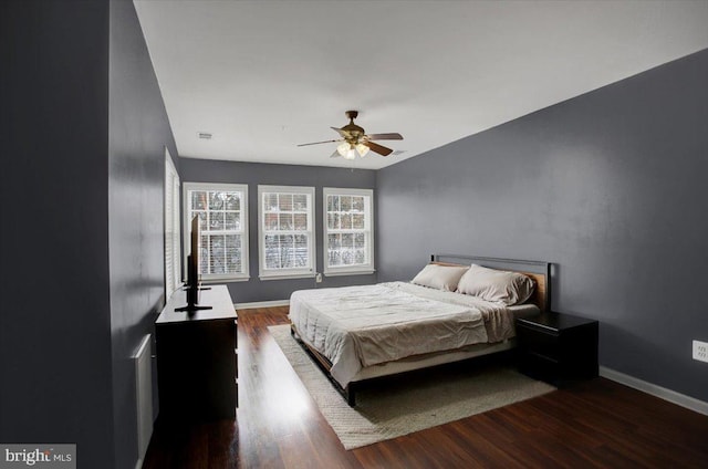 bedroom featuring ceiling fan and dark wood-type flooring