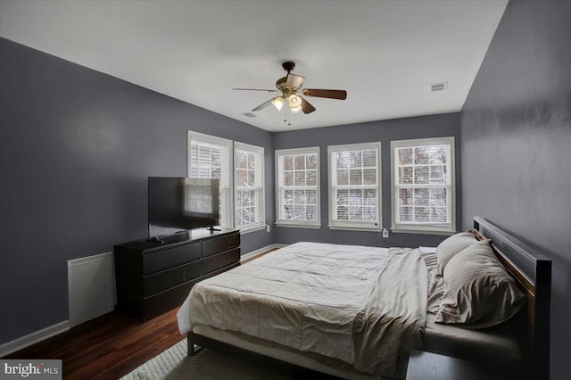 bedroom with ceiling fan and dark hardwood / wood-style floors