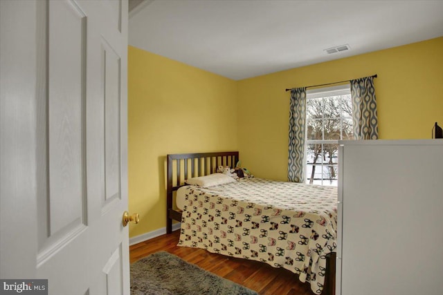 bedroom with hardwood / wood-style flooring