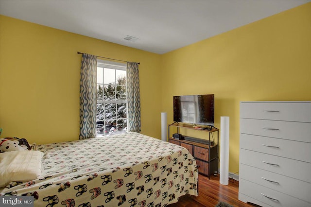 bedroom with dark hardwood / wood-style flooring