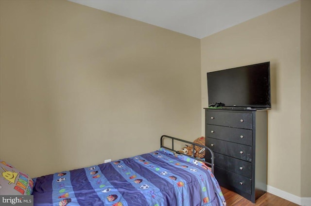 bedroom with hardwood / wood-style floors