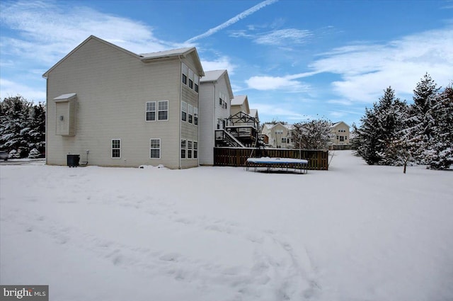 view of snow covered exterior with cooling unit