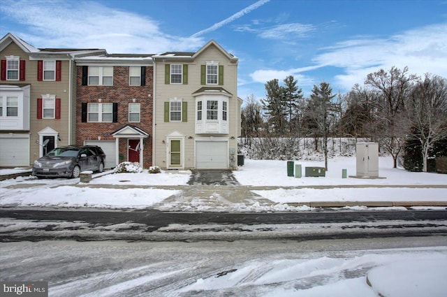 view of property featuring a garage and central air condition unit