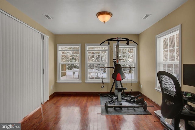 workout area with hardwood / wood-style flooring