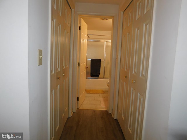 hallway with hardwood / wood-style floors