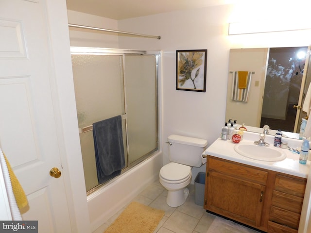 full bathroom with tile patterned floors, shower / bath combination with glass door, vanity, and toilet