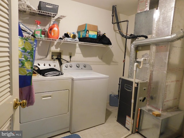 laundry area with washer and dryer and heating unit