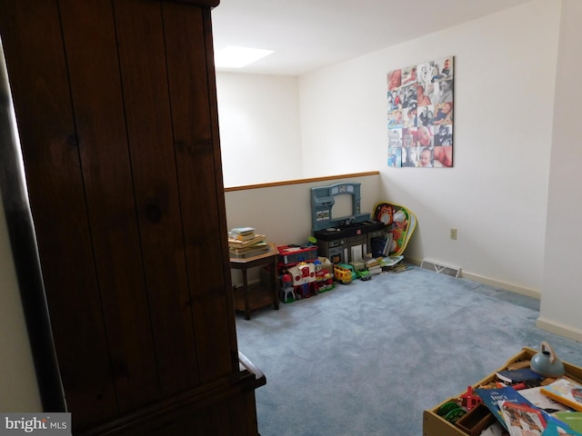 recreation room with light carpet