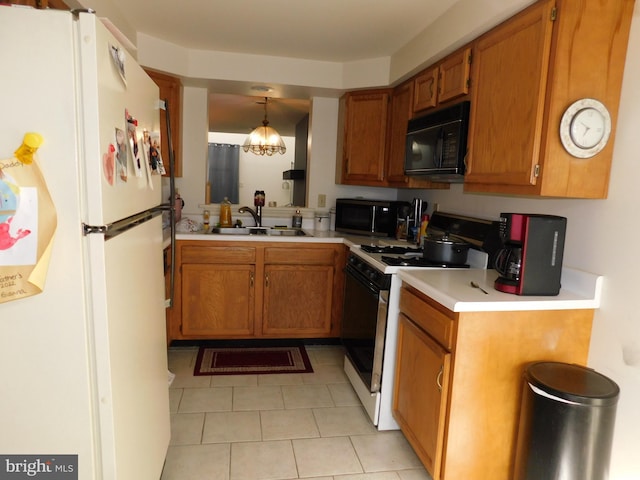 kitchen with pendant lighting, white appliances, sink, light tile patterned flooring, and a chandelier