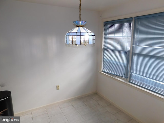 unfurnished dining area featuring a notable chandelier