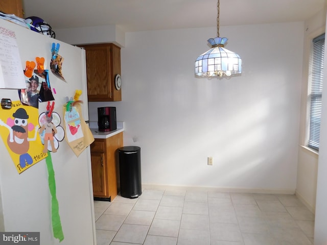 kitchen with white fridge and hanging light fixtures