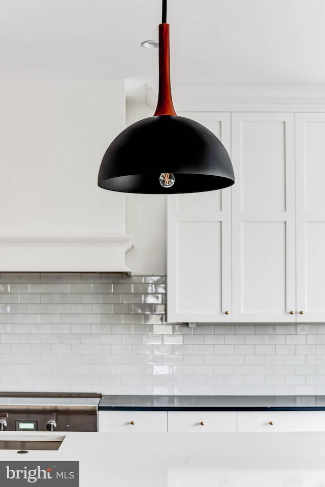 room details with white cabinets and decorative backsplash