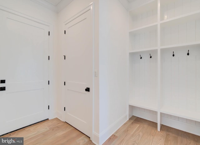 mudroom with hardwood / wood-style flooring and crown molding