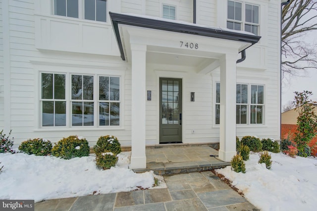 view of snow covered property entrance