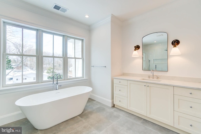 bathroom featuring vanity, a bath, and ornamental molding