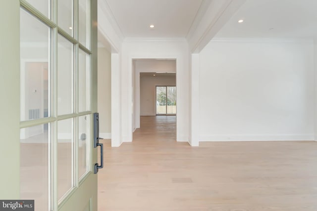 hall featuring crown molding and light wood-type flooring