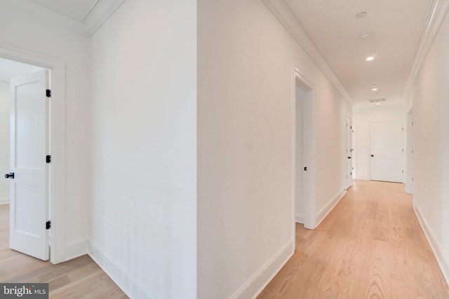 corridor with crown molding and light wood-type flooring