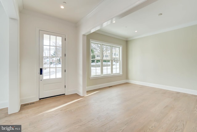 entryway featuring crown molding and light hardwood / wood-style flooring