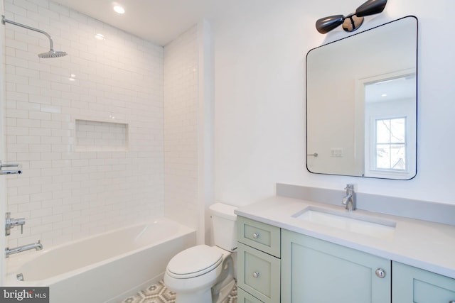 full bathroom featuring vanity, toilet, and tiled shower / bath