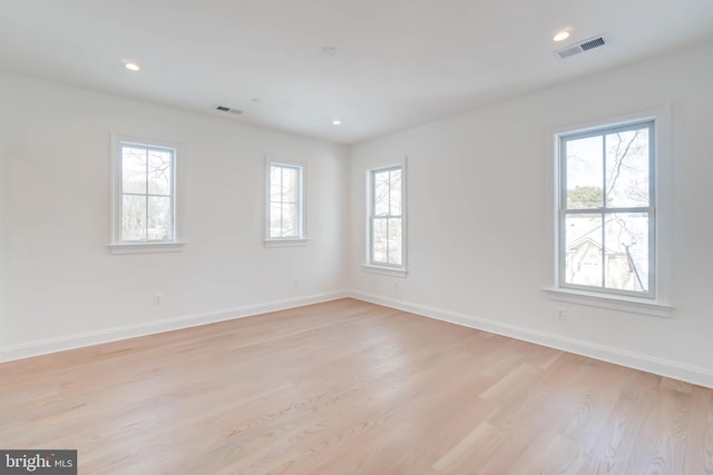 unfurnished room with a wealth of natural light and light wood-type flooring