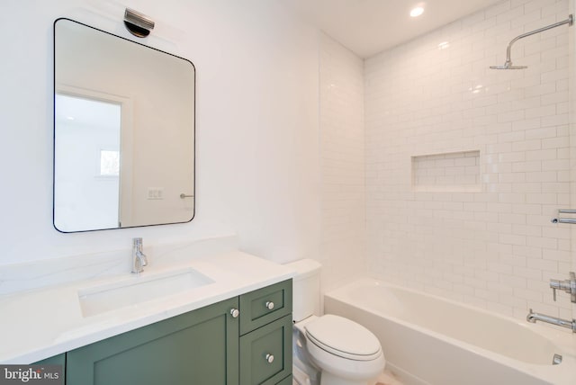 full bathroom featuring vanity, toilet, and tiled shower / bath