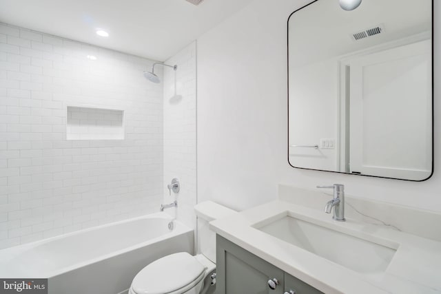 full bathroom featuring toilet, vanity, and tiled shower / bath