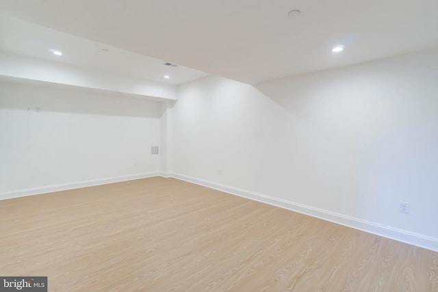 basement with light hardwood / wood-style flooring