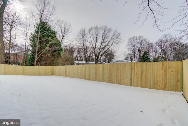 view of yard layered in snow